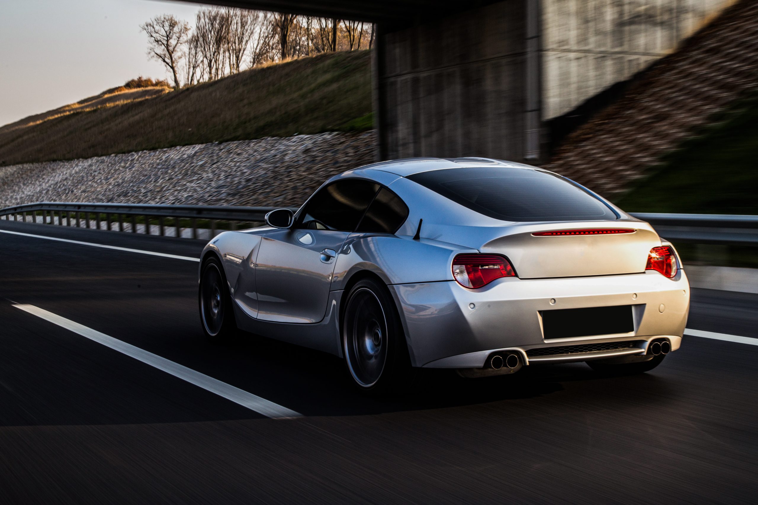 back-side-view-metallic-silver-coupe-road